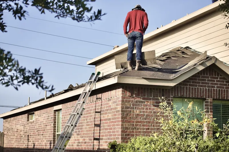 Professional roofer working on a residential roof in Lynch Tract